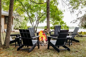 Fire pit with Adirondack chairs and tables
