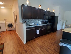 The full kitchen. Washer/dryer down the hall on the left.