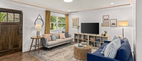 Cozy living room features large television and ample seating for your entire group.