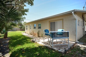 Private patio off of master bedroom with bar top and seating for two.