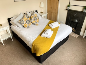 Master bedroom, featuring a comfortable king bed.