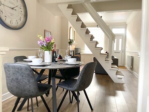 Open plan living, dining area with dining table and four chairs.
