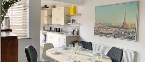 Dining room leading off the kitchen, seating for six guests.