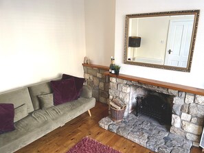 Spacious living room, featuring a double sofa bed & single sofa chair.