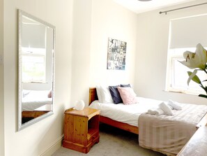 First floor, master back bedroom featuring a king sized bed, chester drawers.