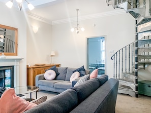 Living room, featuring seating area, smart tv, traditional fire.