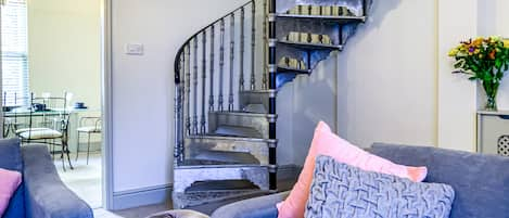 Living room featuring a quirky spiral staircase.