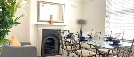 Spacious dining room with large dining table table and chairs. 