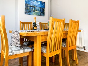 A light airy room with a family dining table with six chairs.