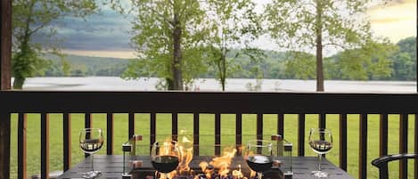 Serene Lake Views from the private 50-foot deck. Enjoy meals, soaking in the hot tub, and relaxing around the fire table on this special deck every morning and night.