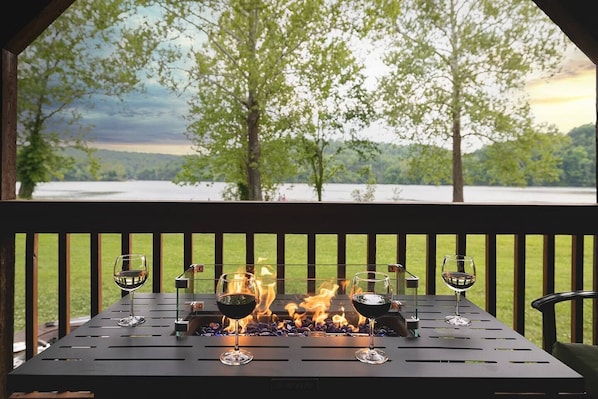 Serene Lake Views from the private 50-foot deck. Enjoy meals, soaking in the hot tub, and relaxing around the fire table on this special deck every morning and night.