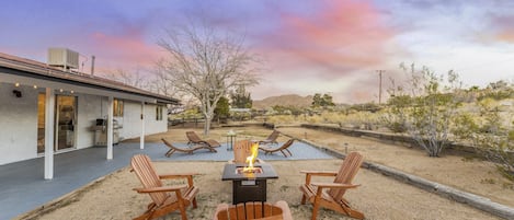 Twilight in the back yard with a fire pit and fiery sky. Happy Hour perhaps?