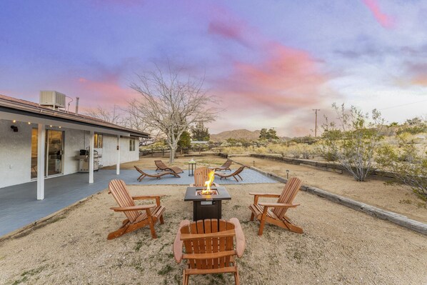 Twilight in the back yard with a fire pit and fiery sky. Happy Hour perhaps?