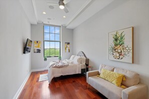 Smartly designed common space with a comfy couch, smart TV, and nice natural light.  All you have to do is log into your favorite streaming services and make it a TV night.