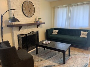 Charming living room with sofa and many chairs