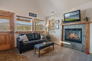 Comfortable living area with TV above the fireplace.