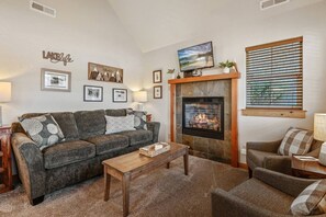 Inviting living area with sofa sleeper and gas insert fireplace.