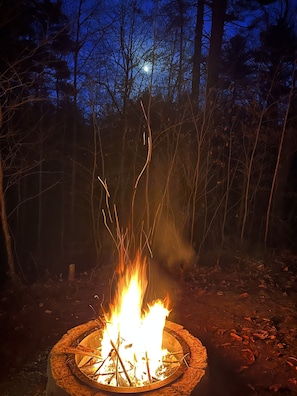 Private backyard firepit with Adirondack chairs. Please supply the wood