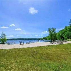 View of the expansive private beach on pristine Moose Pond.