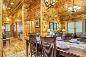 Spacious dining with tall ceilings and recessed lighting.