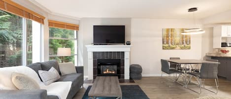 Spacious living area with gas fireplace and TV