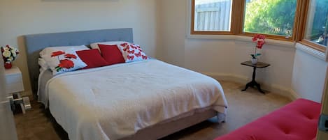 Red Tulip bedroom overlooking front garden: 1 queen bed and futon sofa bed.