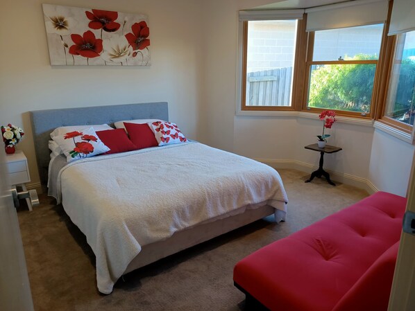 Red Tulip bedroom overlooking front garden: 1 queen bed and futon sofa bed.