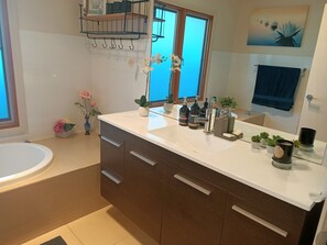 Spacious bathroom with bath tub and shower