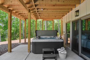 Unwind in the private hot tub surrounded by nature.