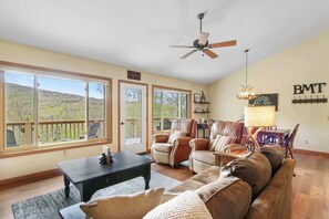 Savor Mountain Views: Delight in scenic beauty from the comfort of the living area's cozy sofa, creating a perfect spot for relaxation with a view.