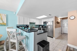The kitchen counter provides additional space for serving snacks or meals.