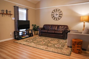 Living rooms has 50" smart TV and nice open and spacious feel.