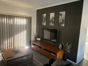 Lounge room with wall mounted smart TV