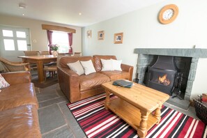 Beckside Cottage sitting room with log burner and dining area