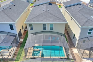Aerial view of the house, pool secured with screen