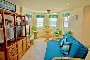 Rounded alcove dining area & sitting area with TV