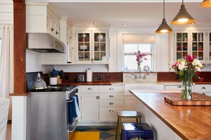 Fully stocked kitchen includes dual ovens, garbage disposal, refrigerator