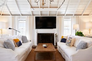 Main floor living room with 60-inch smart TV.
