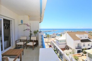 Side view of the balcony with outdoor seating area and sea views