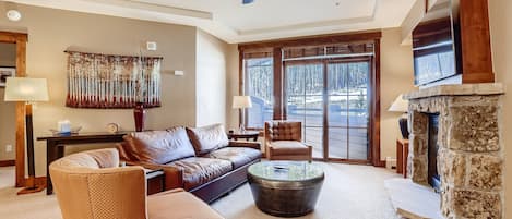 Living room with sofa bed, fireplace, and TV