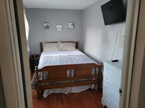 double bed with window air conditioner. swivel TV with roku
