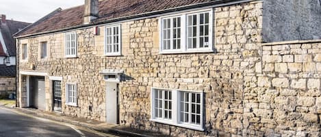 Stunning exterior of the 18th-century Georgian cottage with a modern yet cosy feel on the inside.