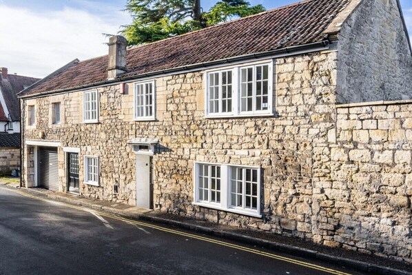 Stunning exterior of the 18th-century Georgian cottage with a modern yet cosy feel on the inside.