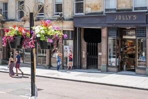 The entrance to the building is through these gates, next to Jolly's.