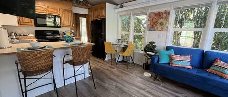 Full kitchen, dining area and living room.