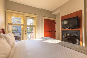 King master bedroom with TV, electric fireplace and a lovely private deck