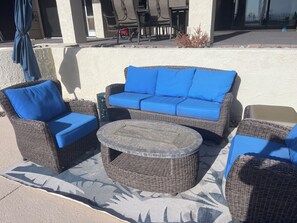 Comfortable wicker seating area on our new Cool Deck around the pool.