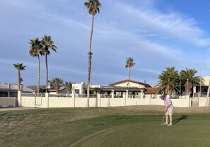 View of the house while standing on the golf course green.