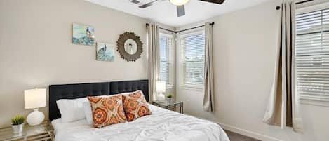 Large bedroom with King size bed, ceiling fan, a closet for clothing storage.