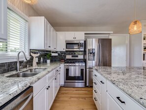 Fully stocked kitchen with pots, pans, coffee maker, knives, baking sheets, etc.